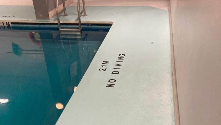 Pools & Decks 5 Pool deck after—close-up, clean surface, “NO DIVING” text clear.