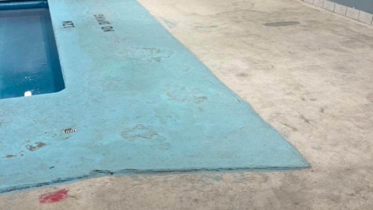 Pools & Decks 8 Pool deck, wide angle before repair, visible patching and discoloration.